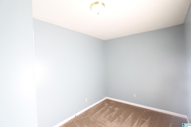 carpeted spare room with baseboards