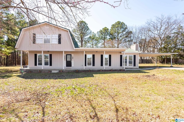 view of front of home featuring a chimney, covered porch, a gambrel roof, a front yard, and a carport