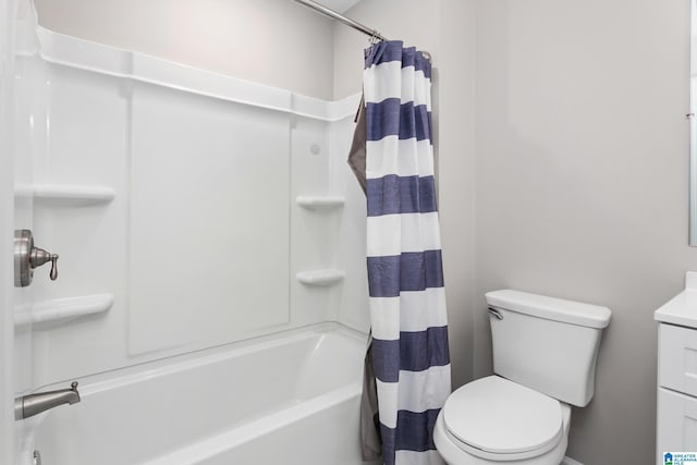 bathroom with toilet, shower / bath combo with shower curtain, and vanity