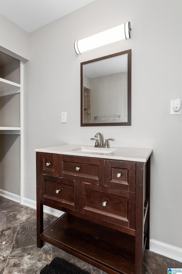 bathroom featuring baseboards and vanity