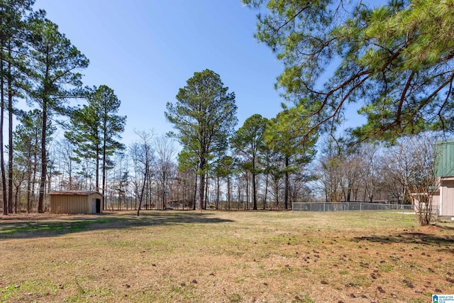 view of yard with fence and an outdoor structure