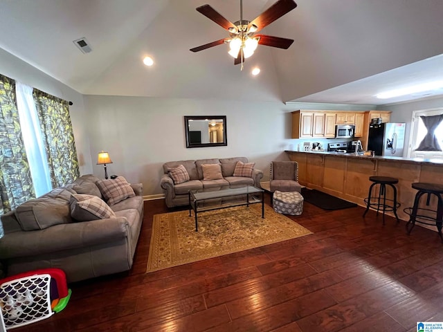 living room with high vaulted ceiling, dark wood-type flooring, visible vents, baseboards, and a ceiling fan