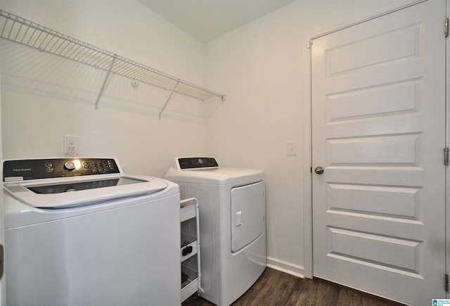 laundry area featuring dark wood-style floors, laundry area, baseboards, and washing machine and clothes dryer