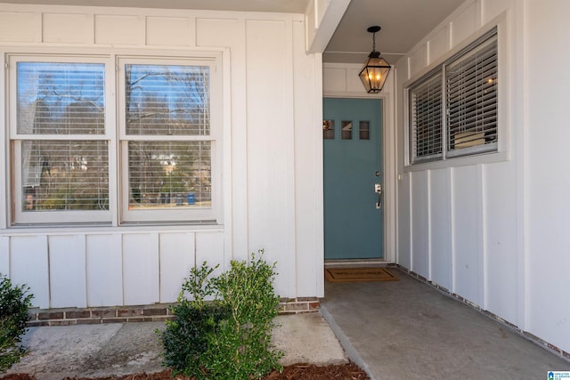 view of exterior entry with board and batten siding