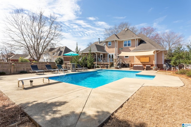 view of swimming pool with a patio, fence, a fenced in pool, and a wooden deck