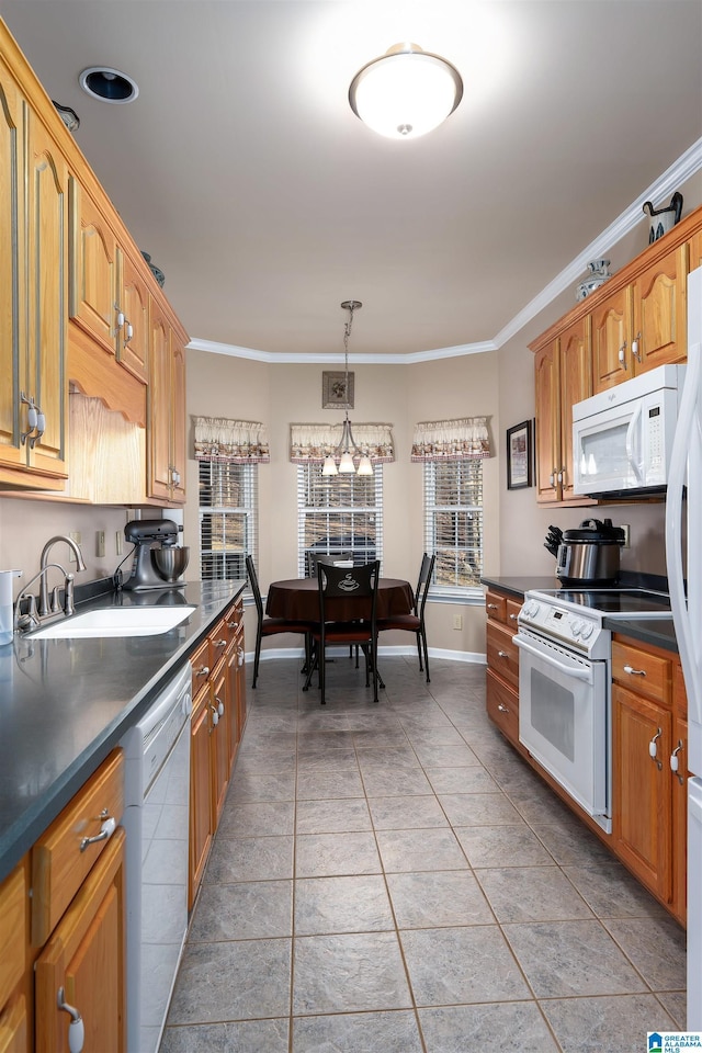 kitchen with white appliances, light tile patterned flooring, ornamental molding, a sink, and dark countertops