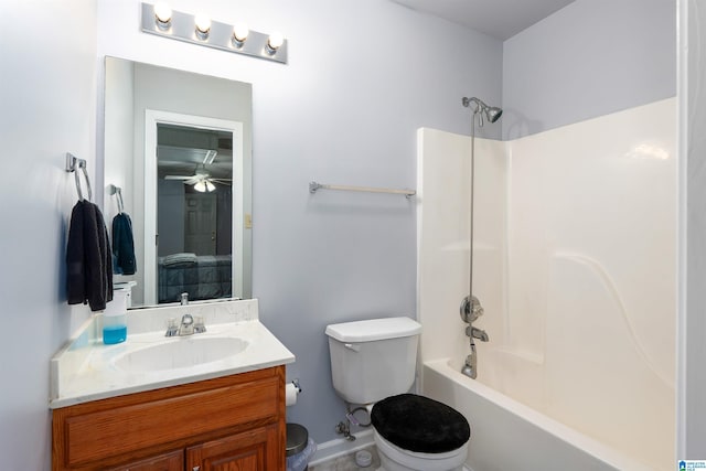 bathroom featuring toilet, vanity,  shower combination, and a ceiling fan