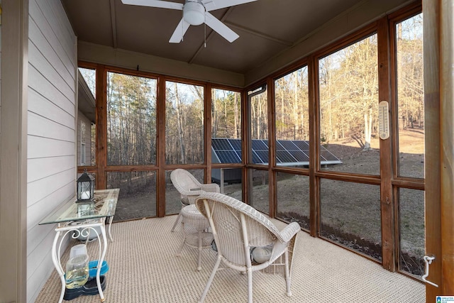 unfurnished sunroom featuring ceiling fan