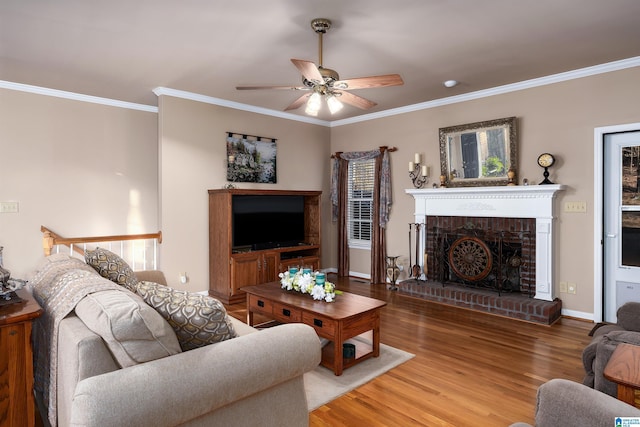 living room with ornamental molding, wood finished floors, and ceiling fan