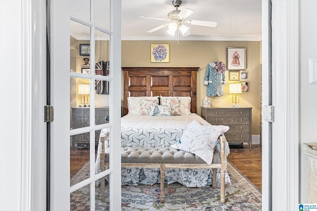 bedroom featuring ceiling fan, crown molding, and wood finished floors