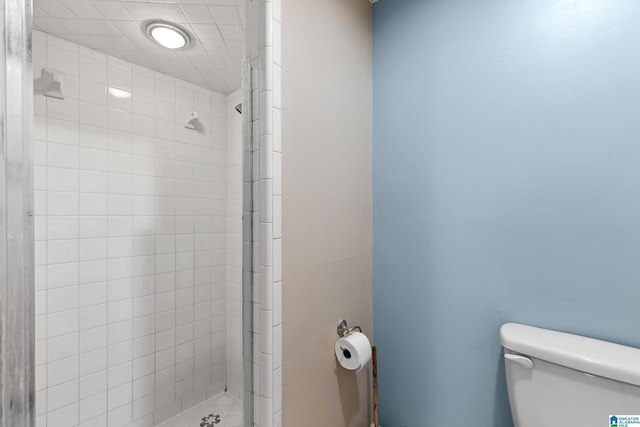 bathroom with toilet and a shower stall