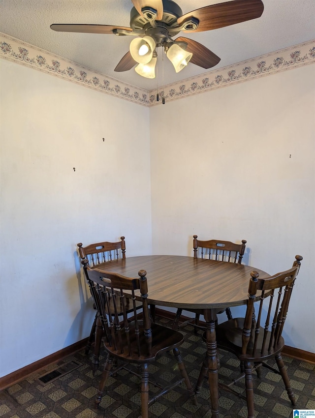 dining area with baseboards, visible vents, ceiling fan, and a textured ceiling