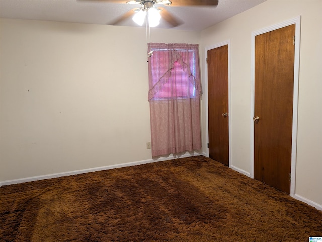 unfurnished bedroom featuring carpet floors, a ceiling fan, baseboards, and multiple closets