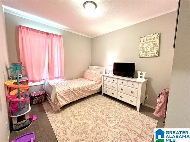 bedroom featuring carpet floors and a textured ceiling