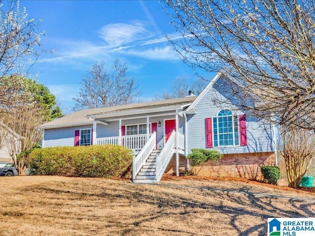 ranch-style home with a porch, a front lawn, and stairs