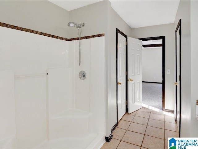 bathroom with tile patterned flooring and a shower