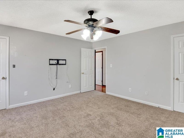 unfurnished bedroom featuring a textured ceiling, carpet flooring, a ceiling fan, and baseboards