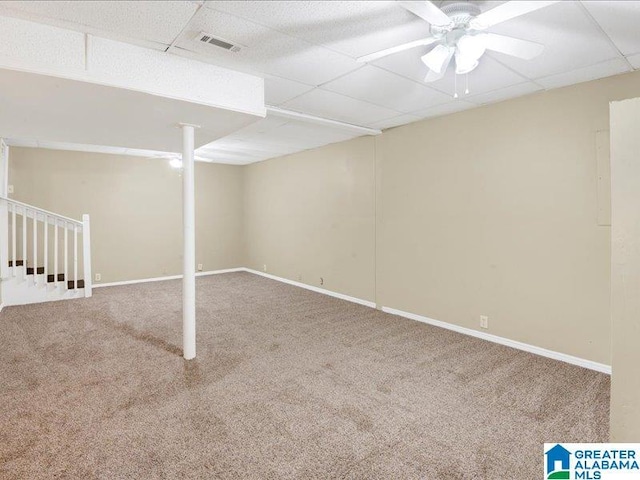 finished below grade area featuring carpet floors, a paneled ceiling, visible vents, and baseboards