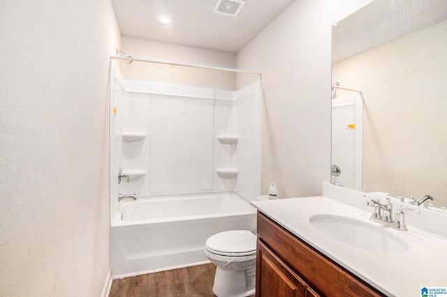 full bathroom with toilet, shower / bath combination, wood finished floors, vanity, and visible vents