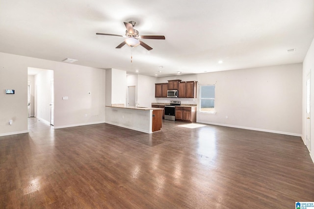 unfurnished living room with ceiling fan, dark wood finished floors, and baseboards