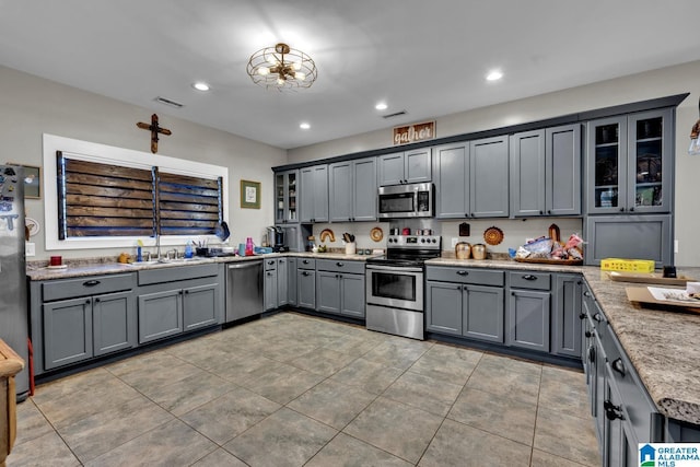 kitchen featuring appliances with stainless steel finishes, recessed lighting, visible vents, and gray cabinetry