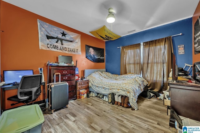 bedroom with wood finished floors and a ceiling fan