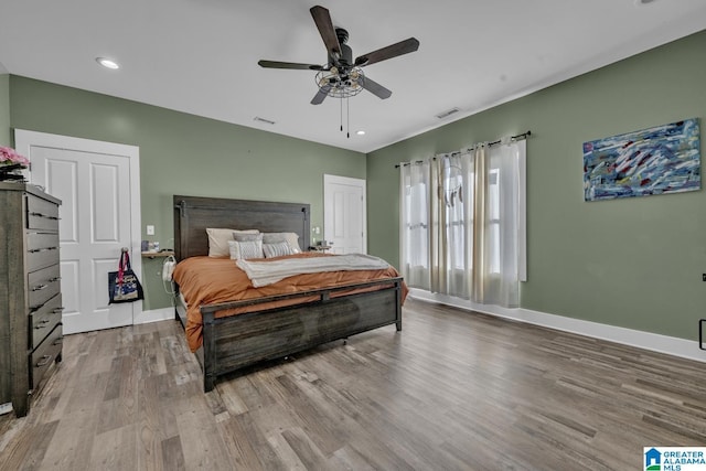 bedroom with recessed lighting, visible vents, a ceiling fan, wood finished floors, and baseboards