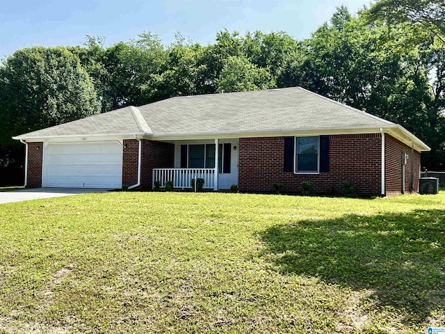 single story home with brick siding, a porch, an attached garage, driveway, and a front lawn