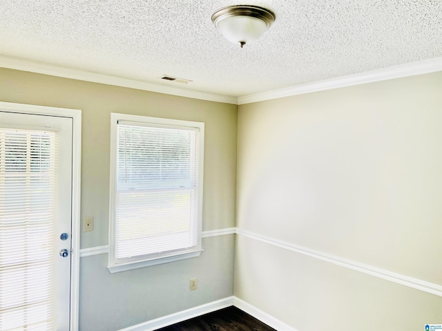 doorway with baseboards, visible vents, dark wood-style floors, crown molding, and a textured ceiling