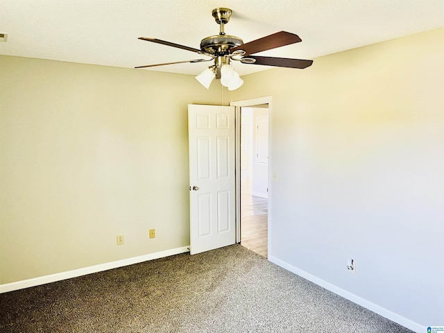 empty room featuring carpet floors, baseboards, and a ceiling fan