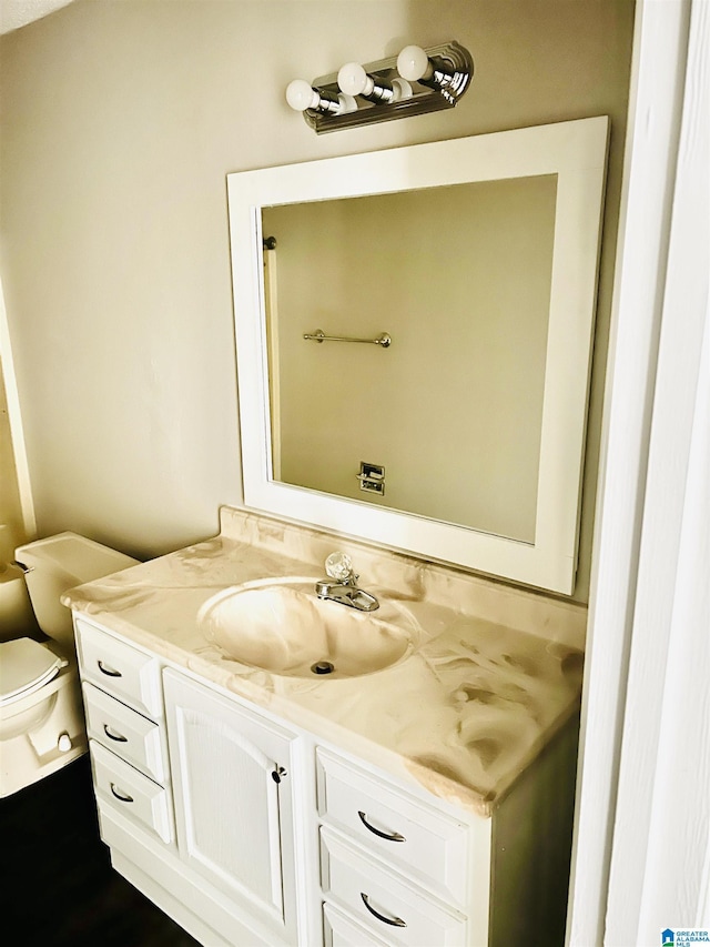 half bathroom featuring toilet and vanity