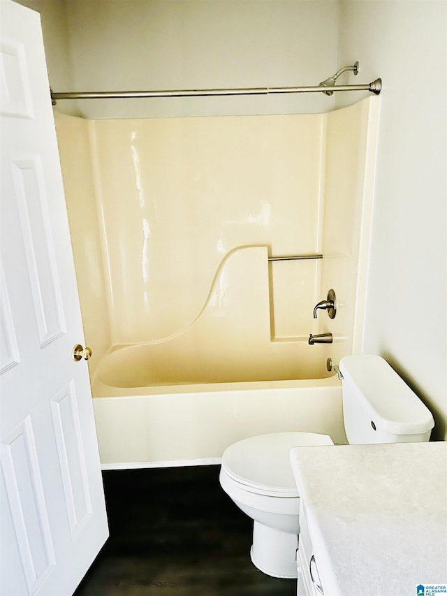 full bathroom featuring  shower combination, toilet, wood finished floors, and vanity