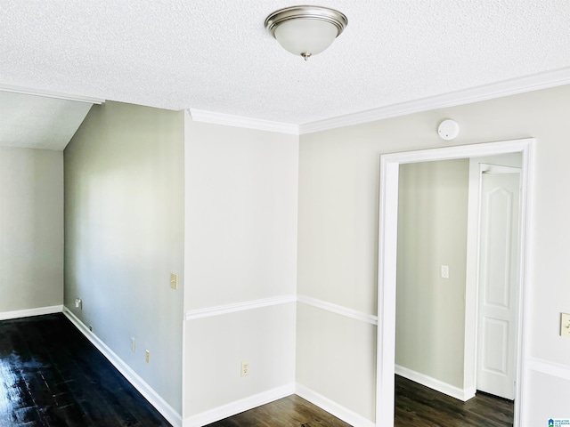 empty room featuring crown molding, a textured ceiling, baseboards, and wood finished floors