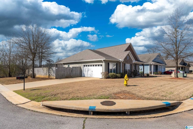 view of front facade featuring an attached garage, fence, and driveway