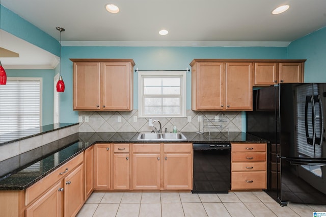 kitchen with black appliances, backsplash, a peninsula, and a sink