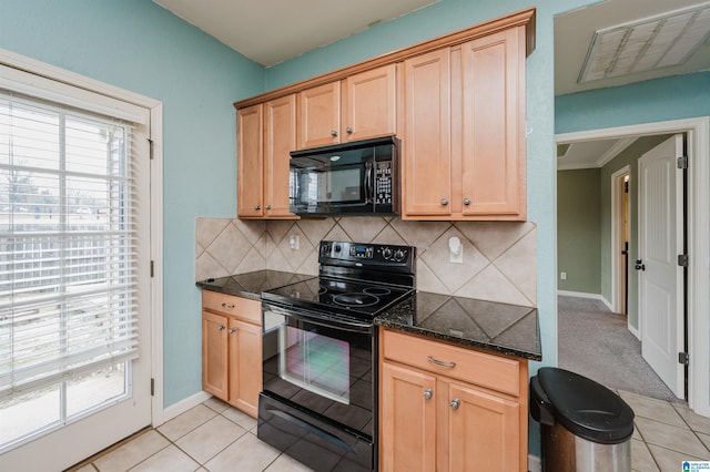 kitchen featuring light tile patterned floors, visible vents, dark stone counters, black appliances, and tasteful backsplash