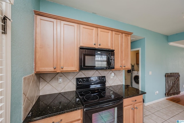 kitchen with tasteful backsplash, washer / clothes dryer, dark stone countertops, black appliances, and open shelves