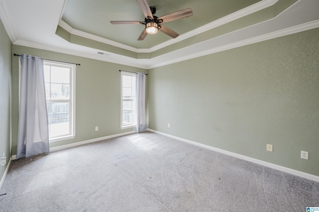 unfurnished room featuring baseboards, visible vents, carpet, a tray ceiling, and crown molding