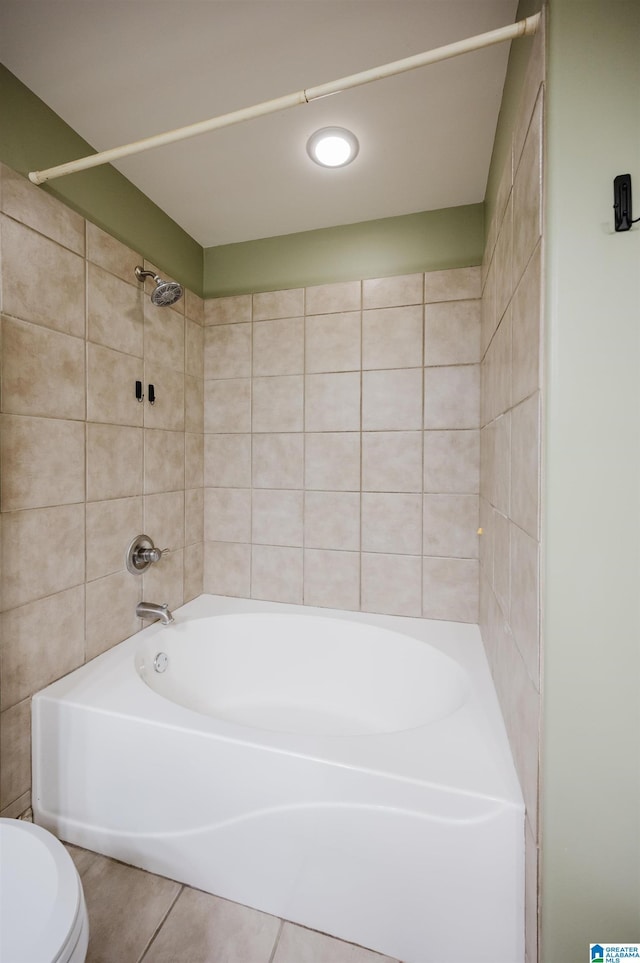 full bath with washtub / shower combination, toilet, and tile patterned floors