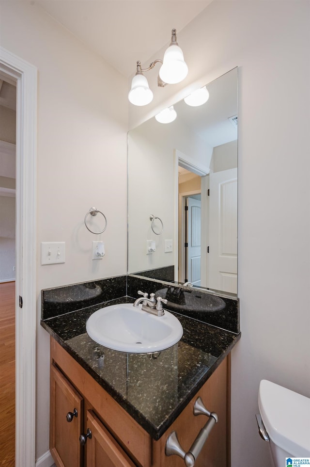 bathroom featuring vanity and toilet