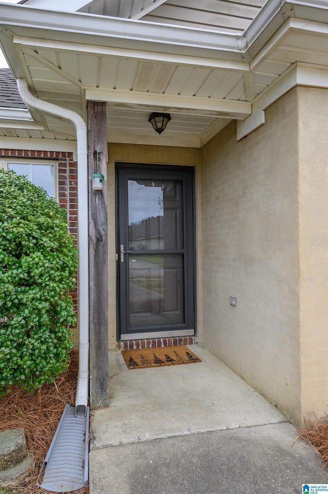 property entrance featuring brick siding