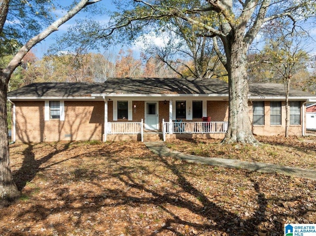 single story home featuring a porch, crawl space, and brick siding