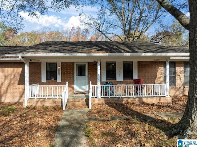 single story home with covered porch and brick siding