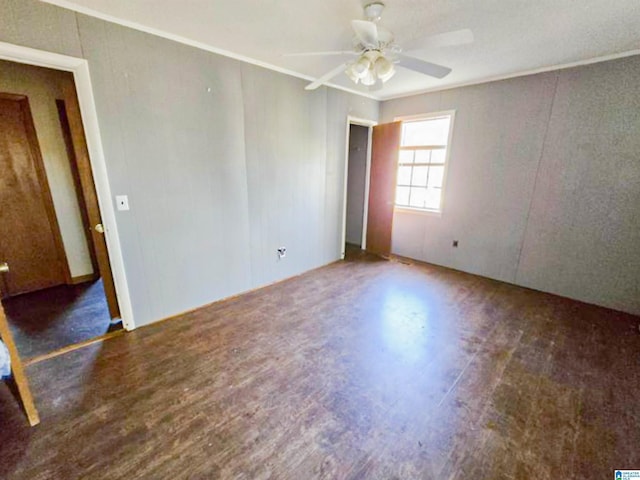 unfurnished room featuring ceiling fan, ornamental molding, and wood finished floors