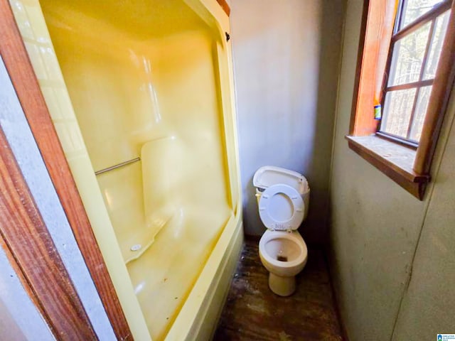 full bathroom featuring toilet, a tub, and a shower