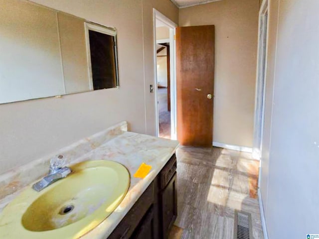 bathroom featuring baseboards, visible vents, and vanity