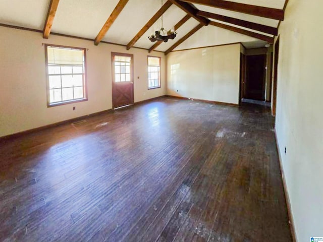 empty room featuring vaulted ceiling with beams, wood-type flooring, baseboards, and a notable chandelier