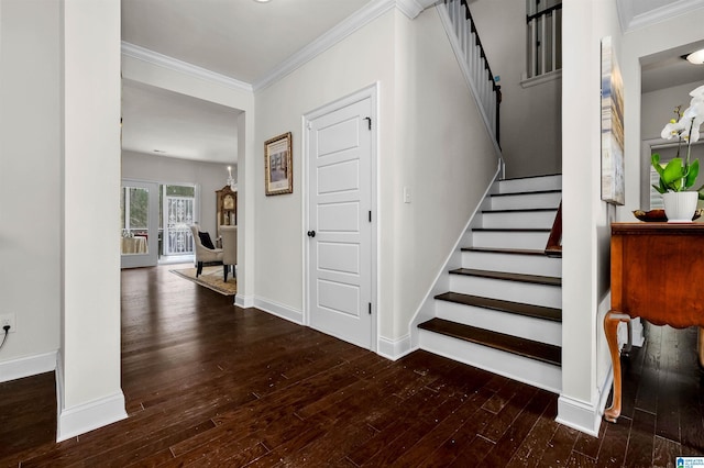 stairs with wood-type flooring, ornamental molding, and baseboards