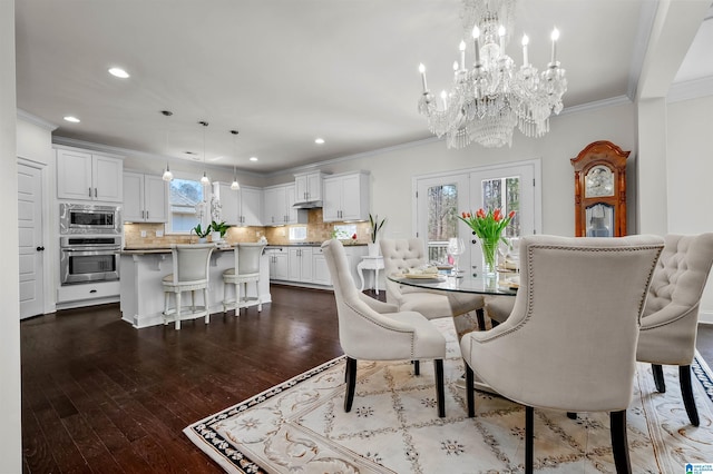 dining room with dark wood-style floors, french doors, ornamental molding, and recessed lighting