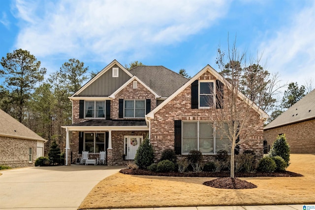 craftsman house featuring brick siding and board and batten siding